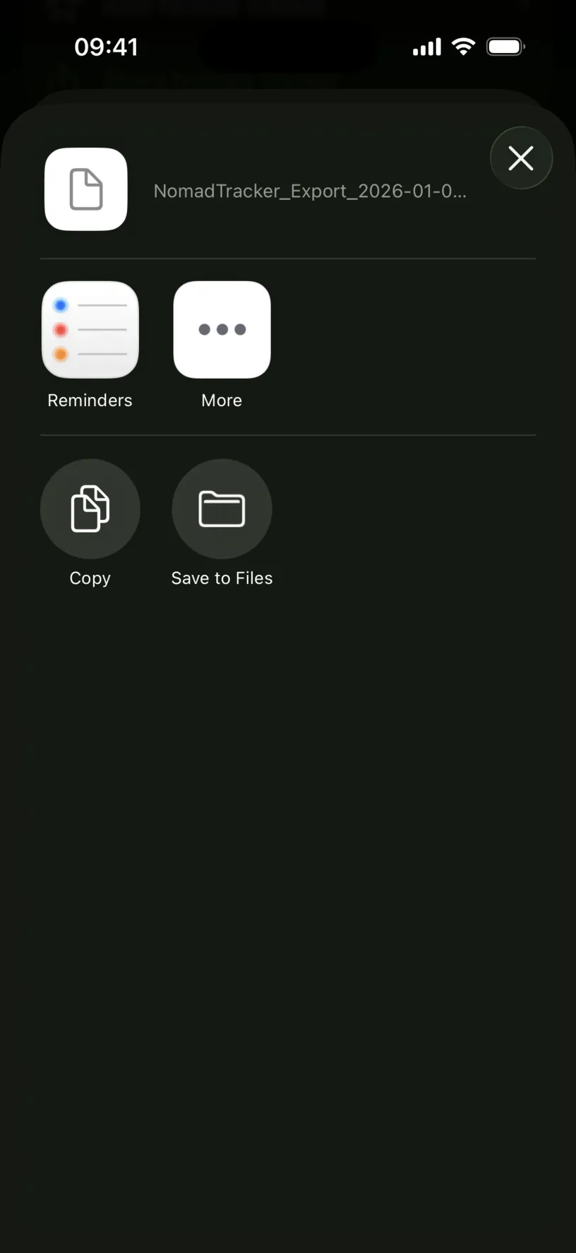The iOS share sheet holding a file named NomadTracker_Export_2026-01-0, with Reminders, More, Copy and Save to Files